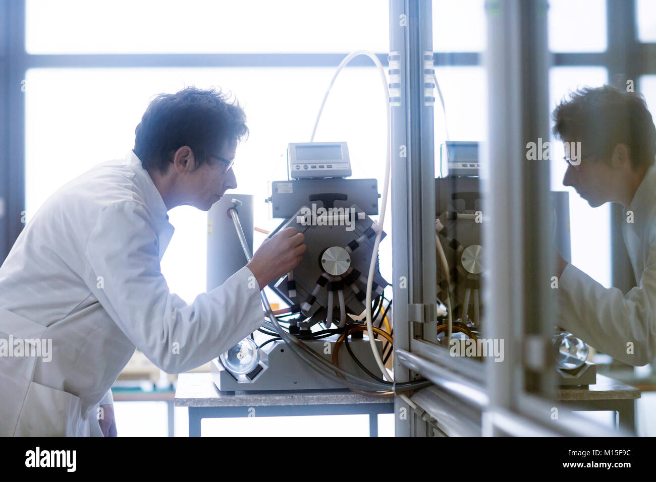 Chemist setting up a vacuum pump in a pharmaceutical laboratory Stock