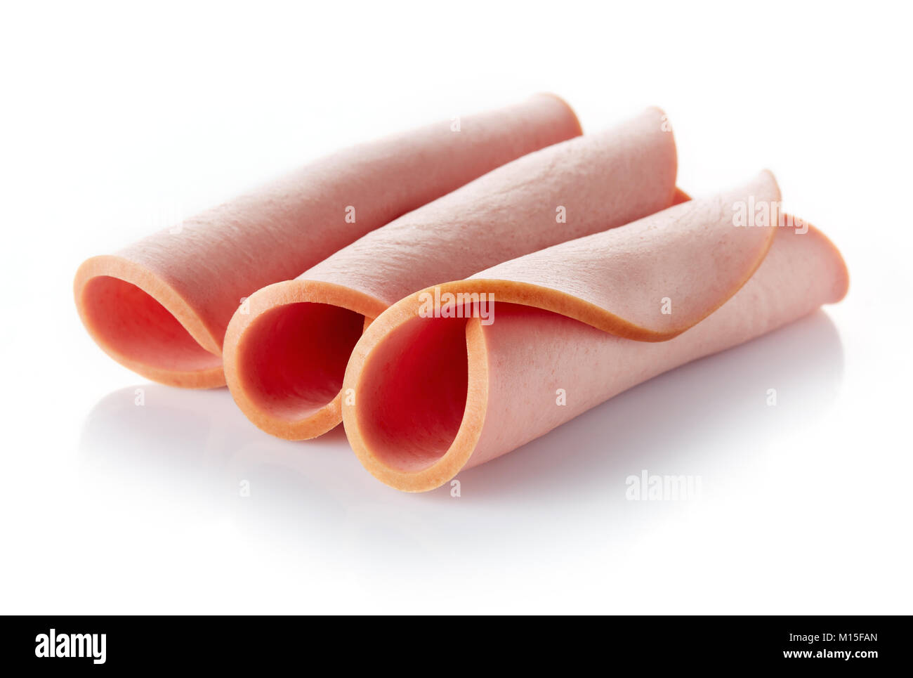 Sliced boiled ham sausage rolls isolated on white background Stock