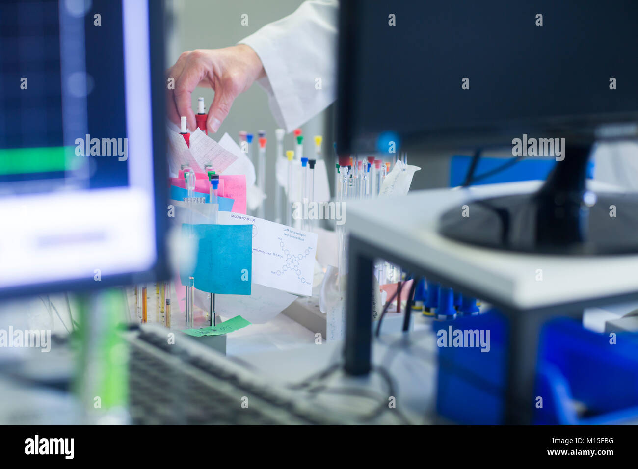 Chemist with NMR (nuclear magnetic resonance) spectroscopy phials in pharmaceutical laboratory. Stock Photo