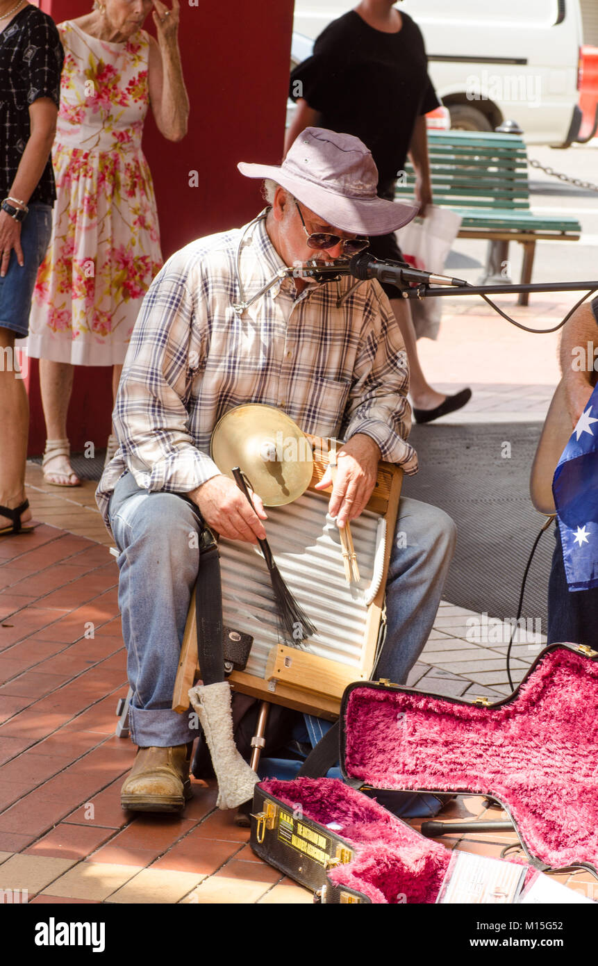 Multi tasking busker playing a harmonica, cymbal and washboard at Tamworth Country Music Festival 2018. Stock Photo