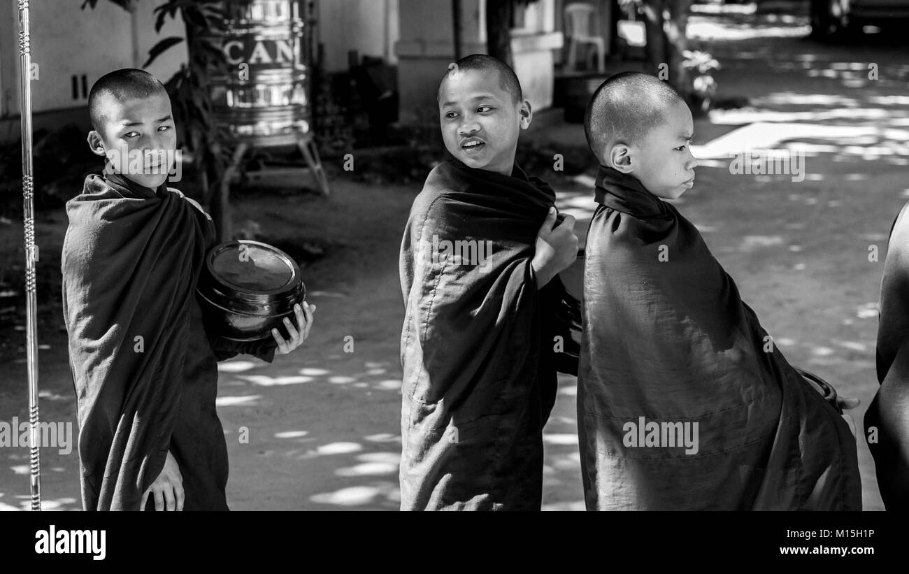 Child praying to monks Black and White Stock Photos & Images - Alamy