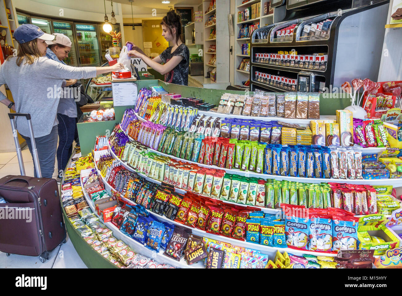 Buenos Aires Argentina,convenience store,snack shop,chocolate bars,cookies,sweets,Hispanic,woman female women,cashier,transaction paying pays buying b Stock Photo
