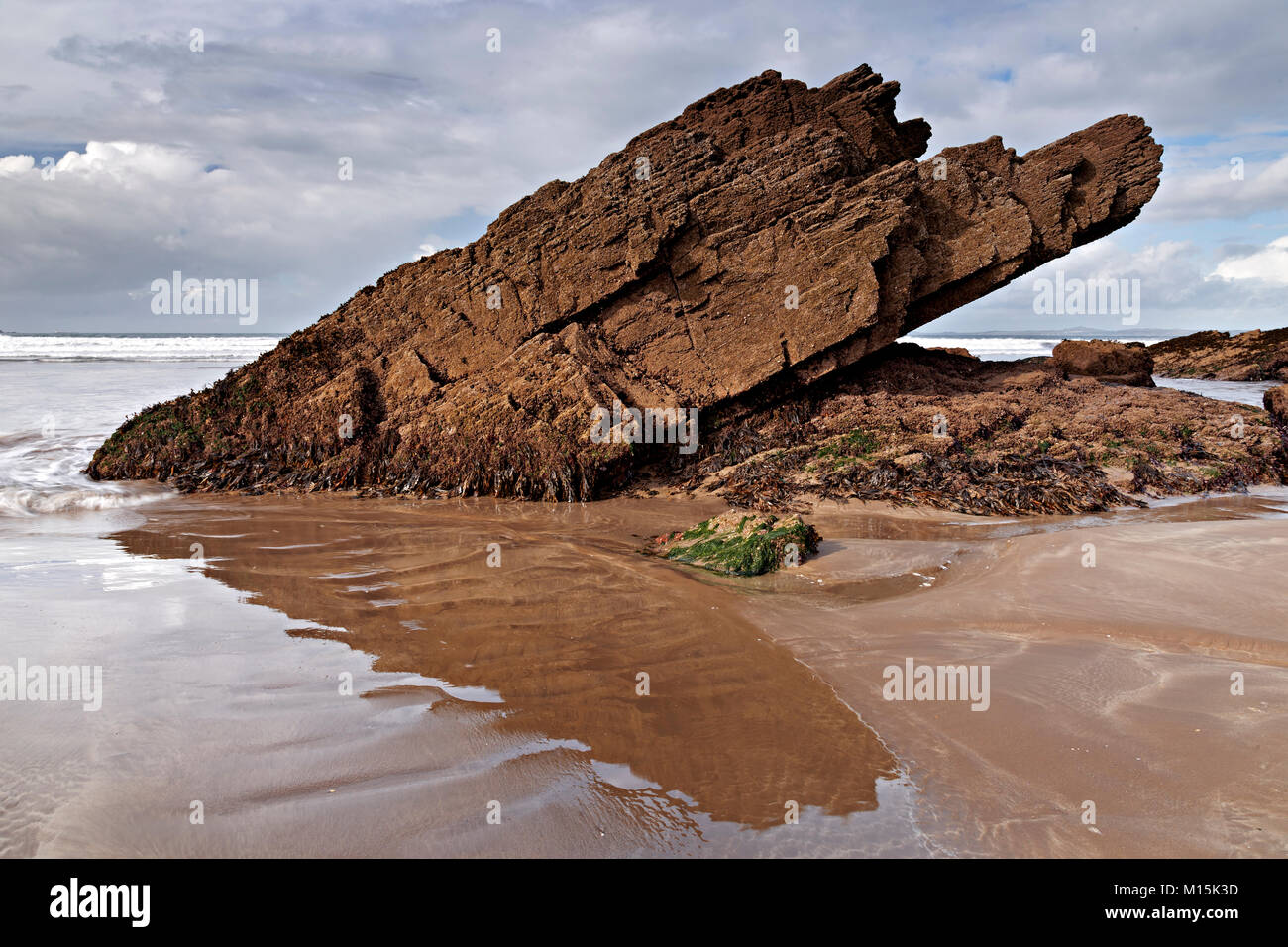 Rock formation in wet sand on the beach at Broad Haven on the Welsh coast Stock Photo