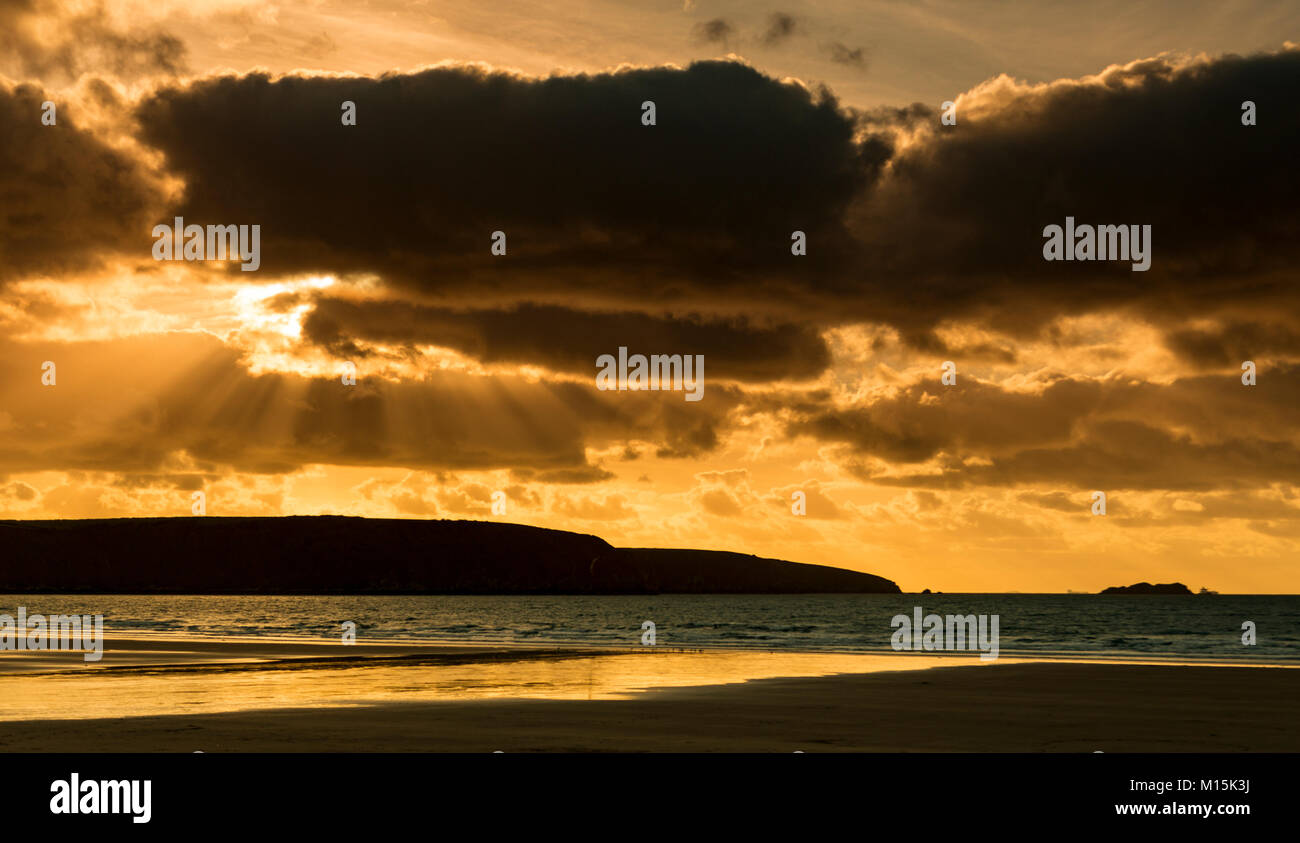 Sunbeams at sunset over the beach at Broad Haven on the Welsh coast Stock Photo