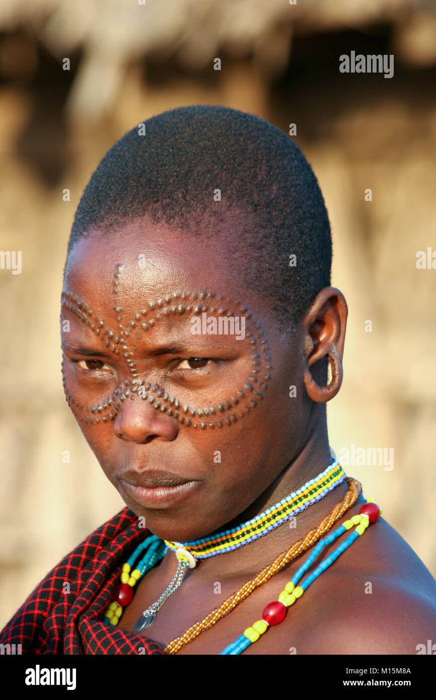 Portrait of a young Datoga woman with beauty scarring around her eyes. Photographed at Lake Eyasi, Tanzania Stock Photo