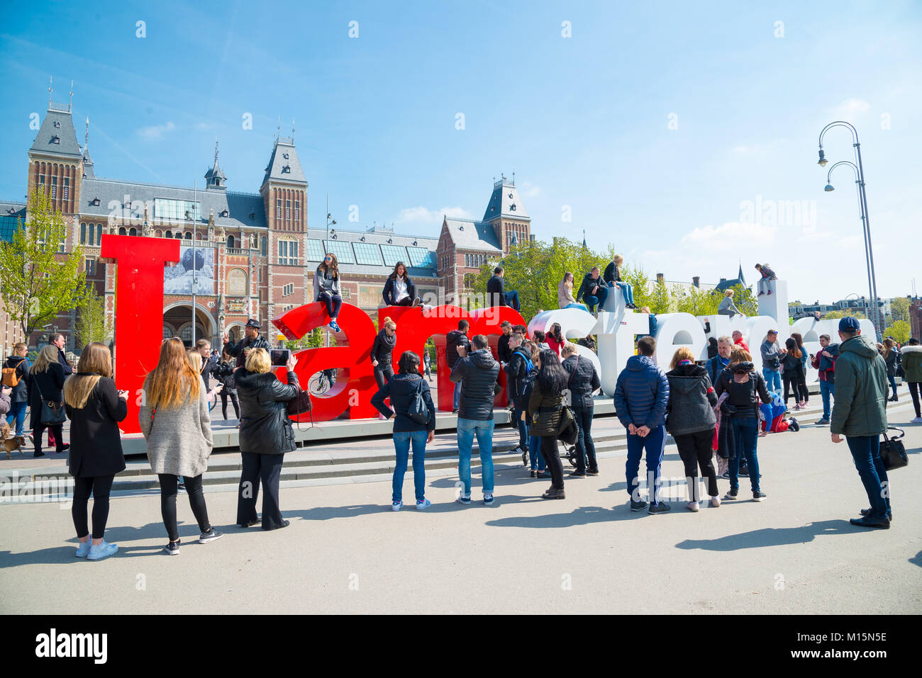 Amsterdam, Netherlands - April 20, 2017: Rijksmuseum - National state museum. And city icon I Amsterdam slogan on Museumplein. Stock Photo