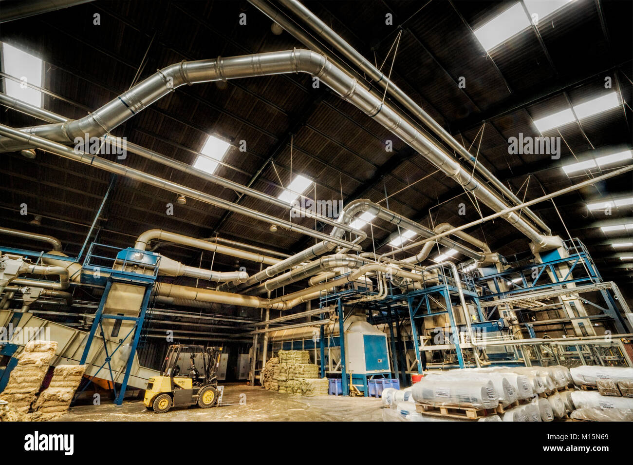 Air conditioning and dust control pipework in a UK plant processing hemp fibre. Stock Photo