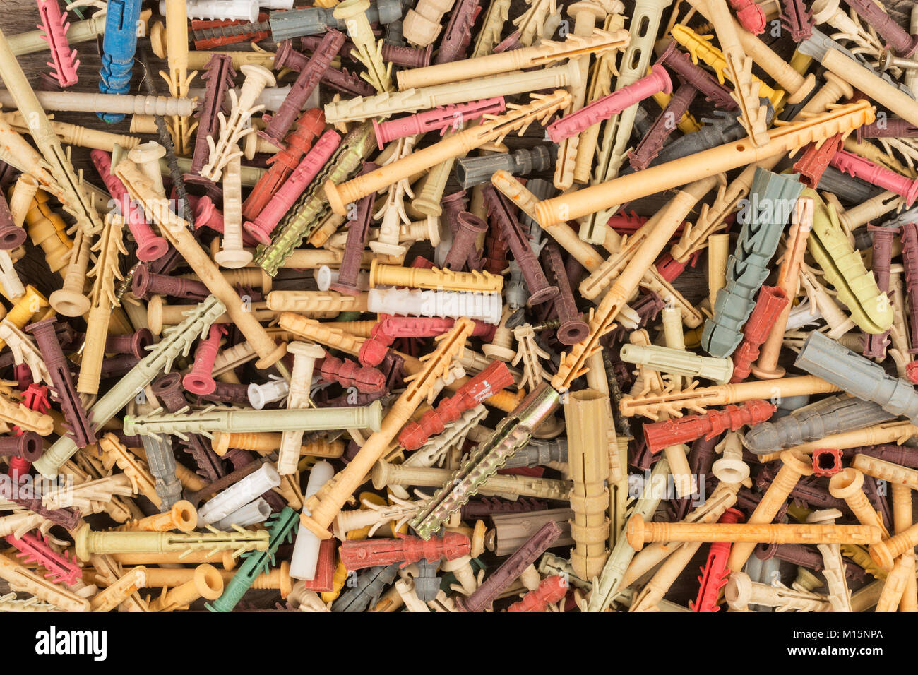 Colored plastic dowels pin or wall plugs. Background with dowel-nails