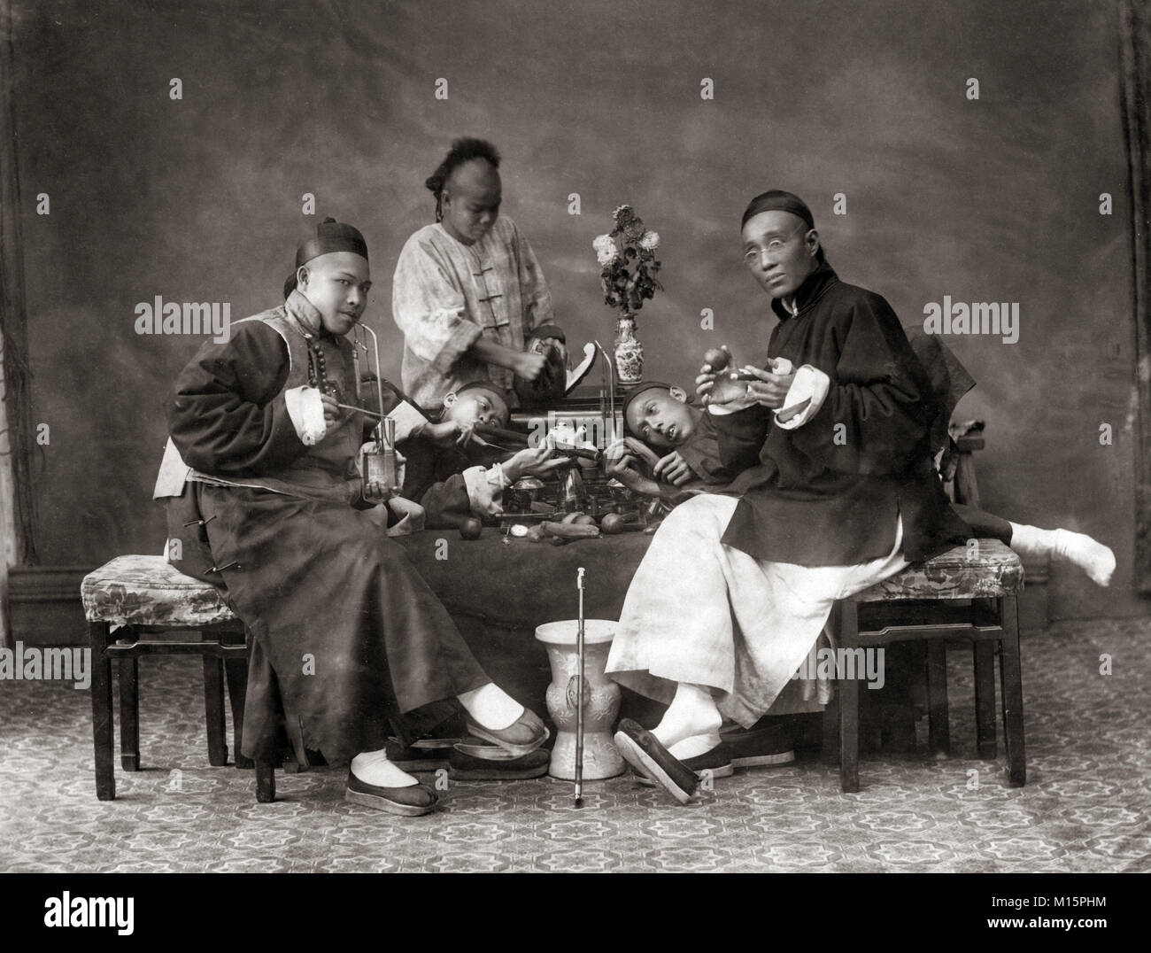 Chinese men smoking opium, China, c.1880's Stock Photo