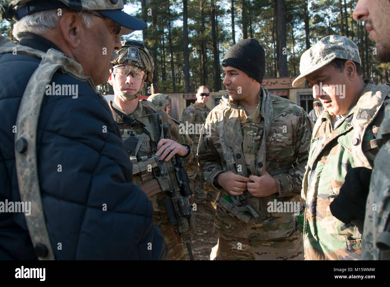 Capt. William Webster, 3rd Battalion, 1st Security Force Assistance Brigade, second from left, works to understand a situation between the simulated Afghan Police and the simulated Afghan National Army during the first-ever SFAB Joint Readiness Training Center rotation Jan. 23, 2018, at Fort Polk, La. SFABs allow the Army to reduce the demand on conventional brigade combat teams over time for combat advising, increasing their readiness for current and emerging threats. (U.S. Army Stock Photo