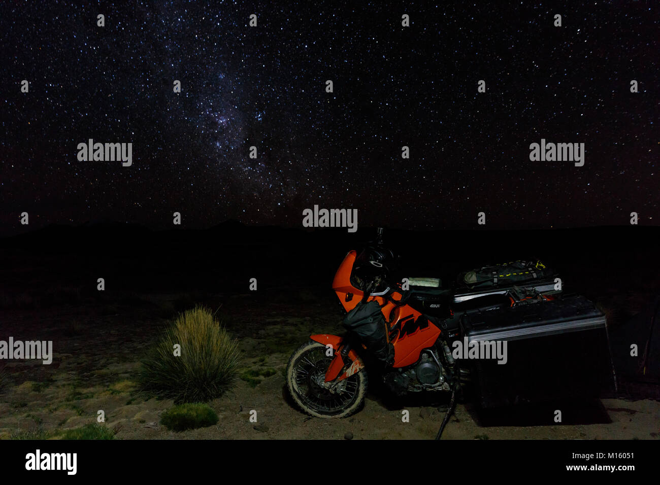 Heavily packed motorcycle on the plateau in front of the starry sky,Putre,Region de Arica y Parinacota,Chile Stock Photo