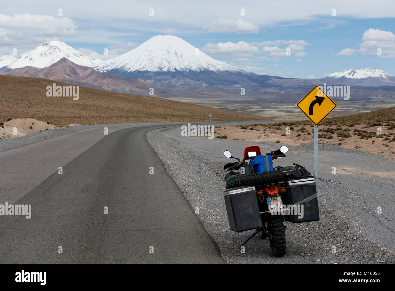 Heavily packed motorcycle at the roadside behind the volcano Pomerape,Putre,Region de Arica y Parinacota,Chile Stock Photo