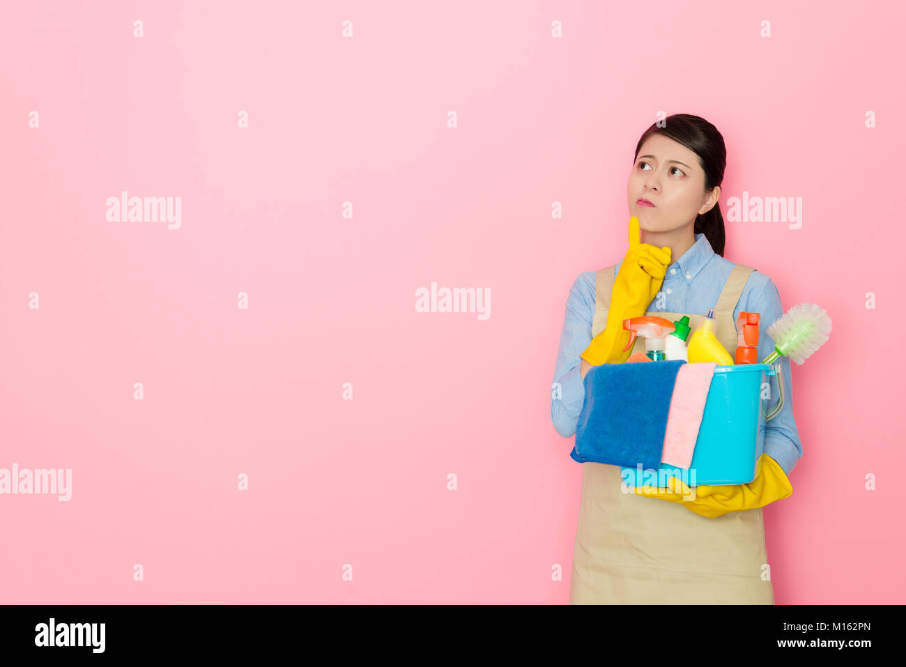 attractive pretty female cleaner worker carrying washing tool standing ...