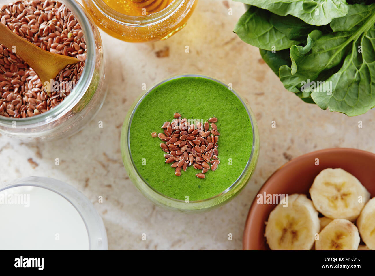 Healthy green smoothie made with spinach, banana and flax seed. Green