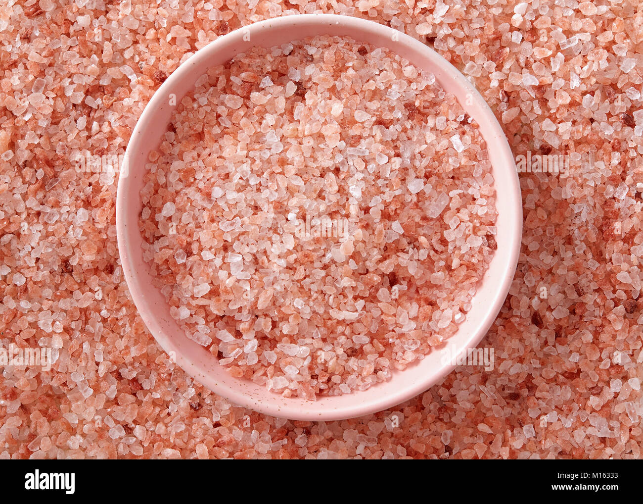 Pink Himalayan salt in the small pink bowl. A small pink bowl full of