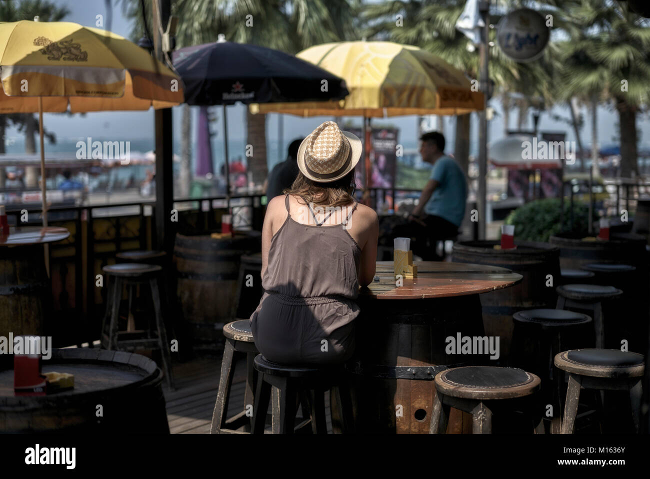 Woman alone in a restaurant bar area. Thailand, Southeast Asia Stock Photo