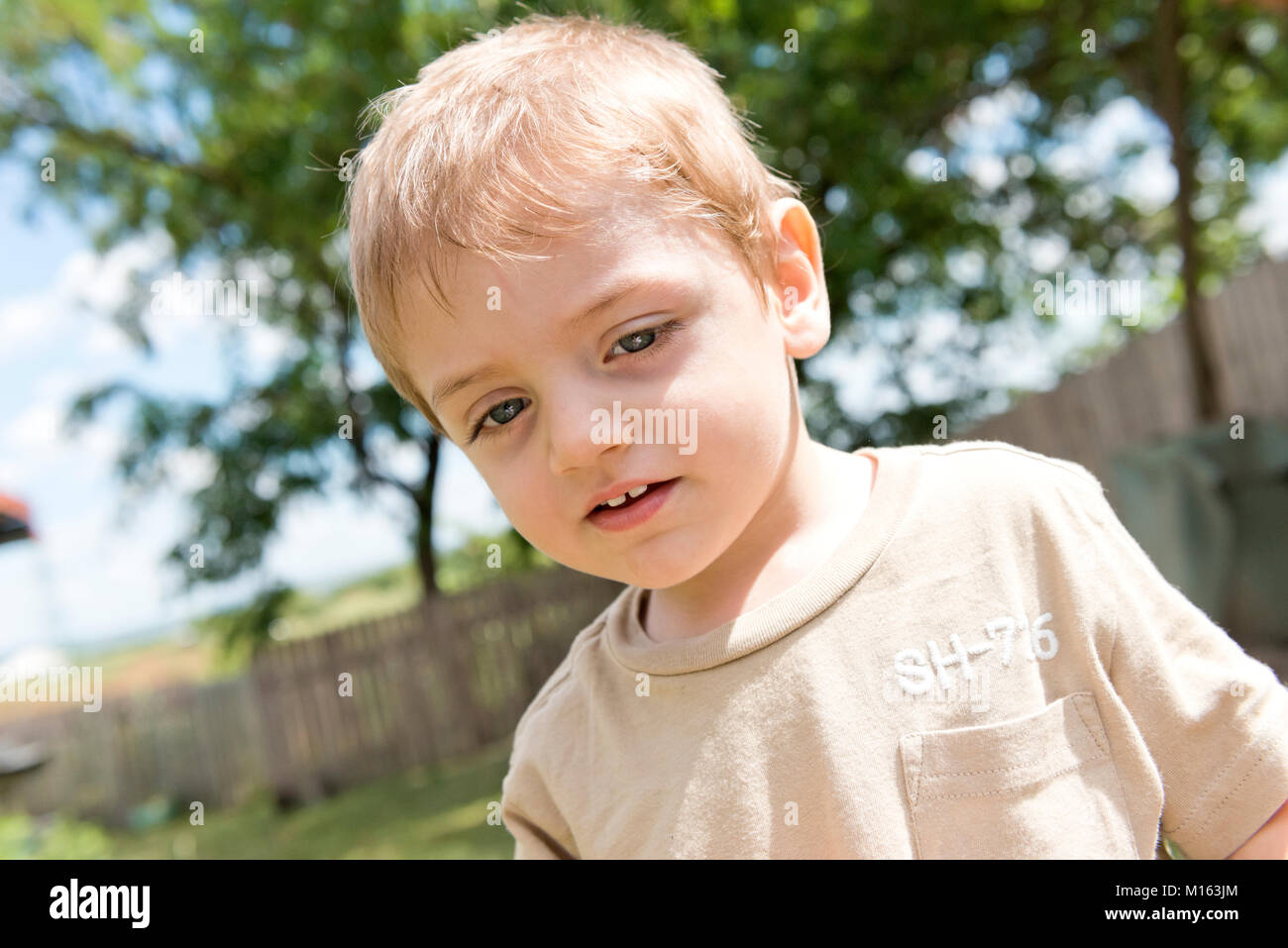 Blonde child with blue eyes, outdoor, portraits. The boy is four years