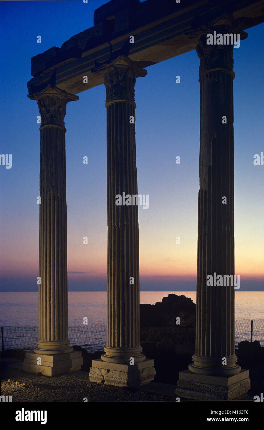 Sunset or Dusk Sets on the Ancient Greek Temple of Apollo (c2nd) in the Remains or Ruins of the Antique Greek City of Side, on the Side Peninsula Overlooking the Mediterranean Sea, Antalya, Turkey Stock Photo