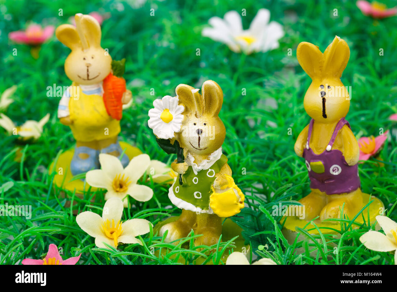 Easter bunny candles on artificial grass background Stock Photo - Alamy