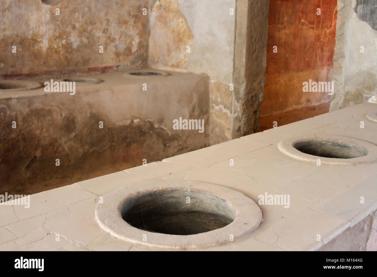 Counters with holes for holding food and drink, Thermopolium of Asellina, Pompeii, Campania, Italy. Stock Photo