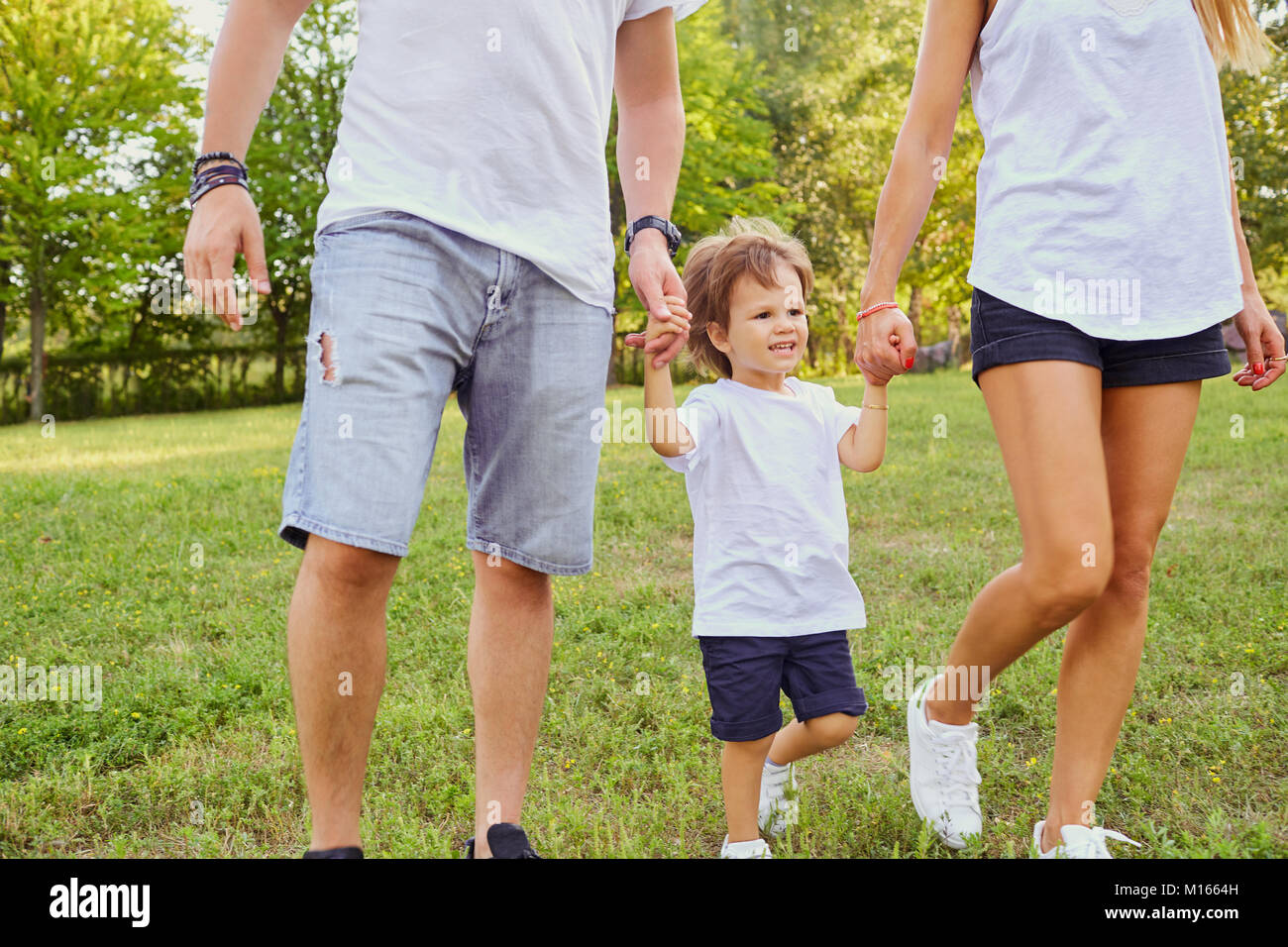 Happy family in the park Stock Photo - Alamy