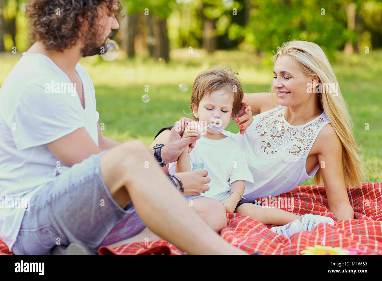 Happy family in the park Stock Photo - Alamy