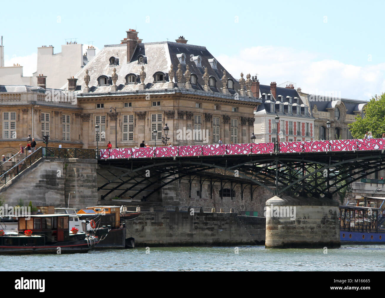 Pont des arts bridge (love lock bridge) and buildings seen on Quai Malaquais Riverside street, Seine River, Paris, France. Stock Photo