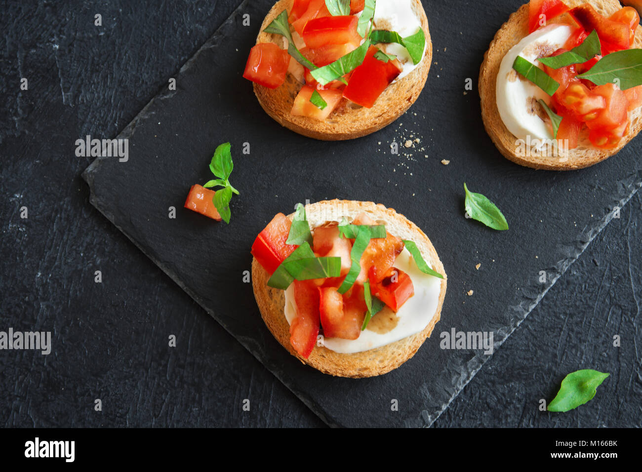 Italian bruschetta with chopped tomatoes, basil, mozzarella cheese and
