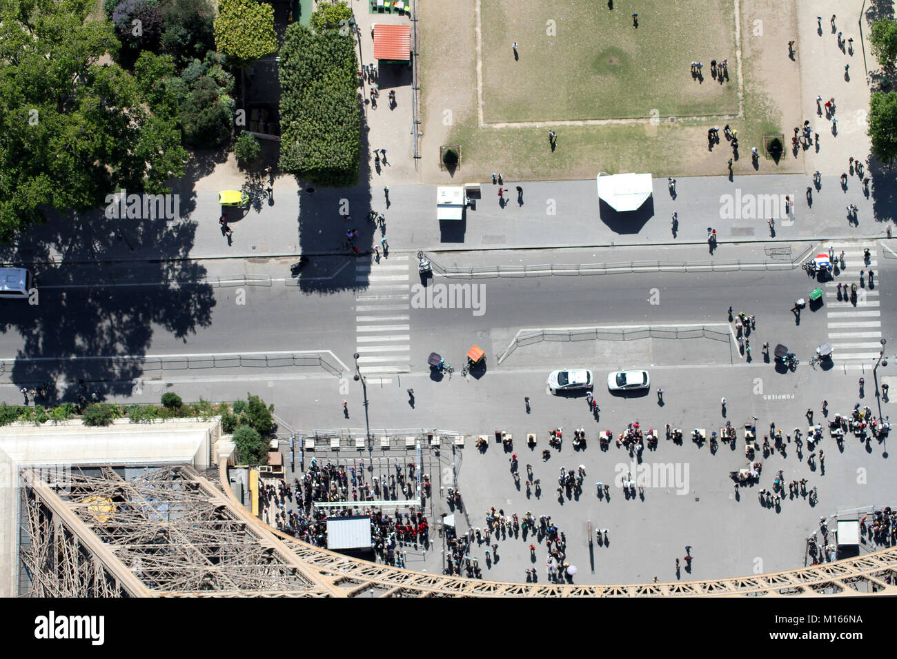 View down of the base of the Eiffel Tower and the street (Avenue Gustave Eiffel) on the Southeast face (Champs de Mars side) from the top of the Eiffe Stock Photo