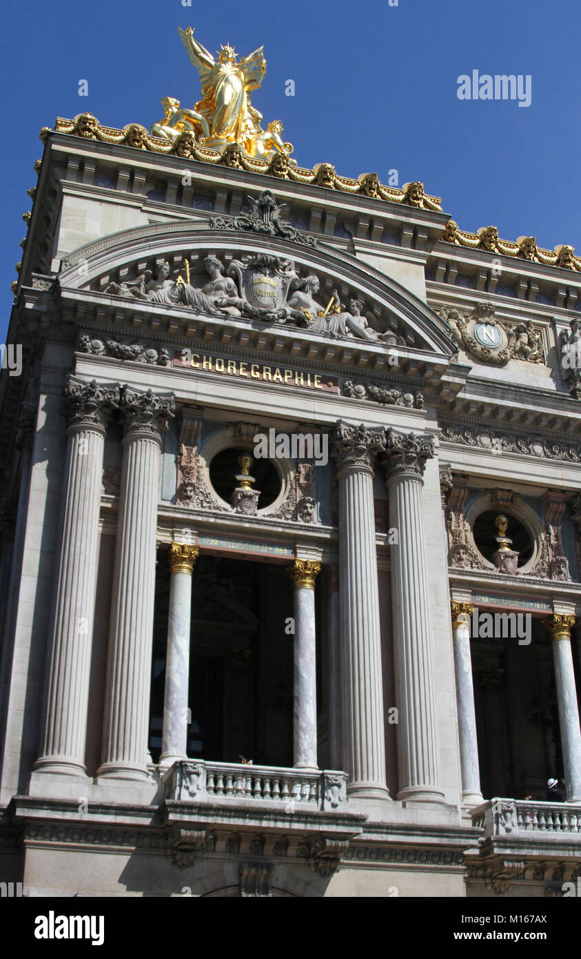Golden statue, reliefs and other decorations on the top left corner of the front of the Palais Garnier opera house, Paris, France. Stock Photo