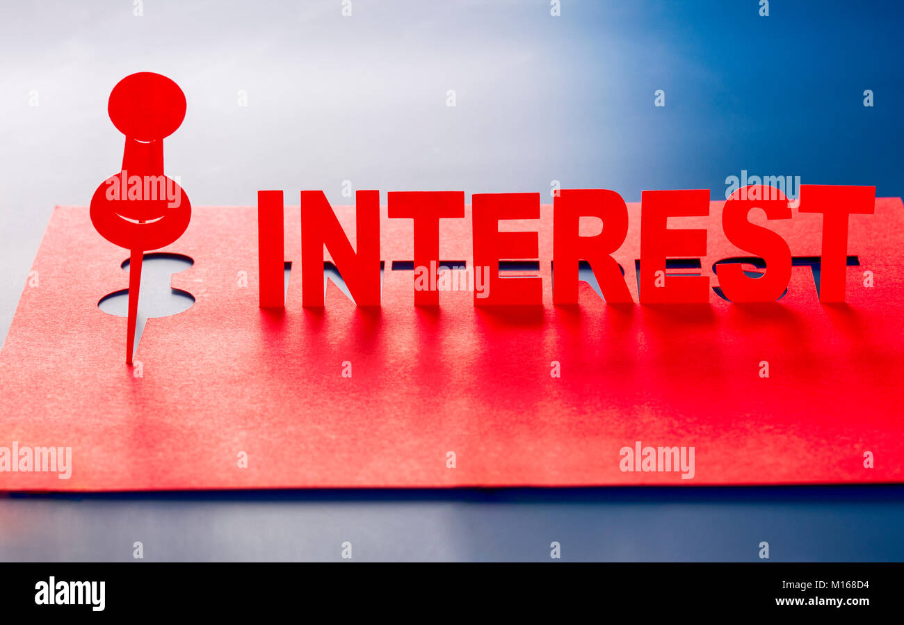 Pinned Interest Pin and word Interest cut out of red paper sheet. Blue background Stock ...