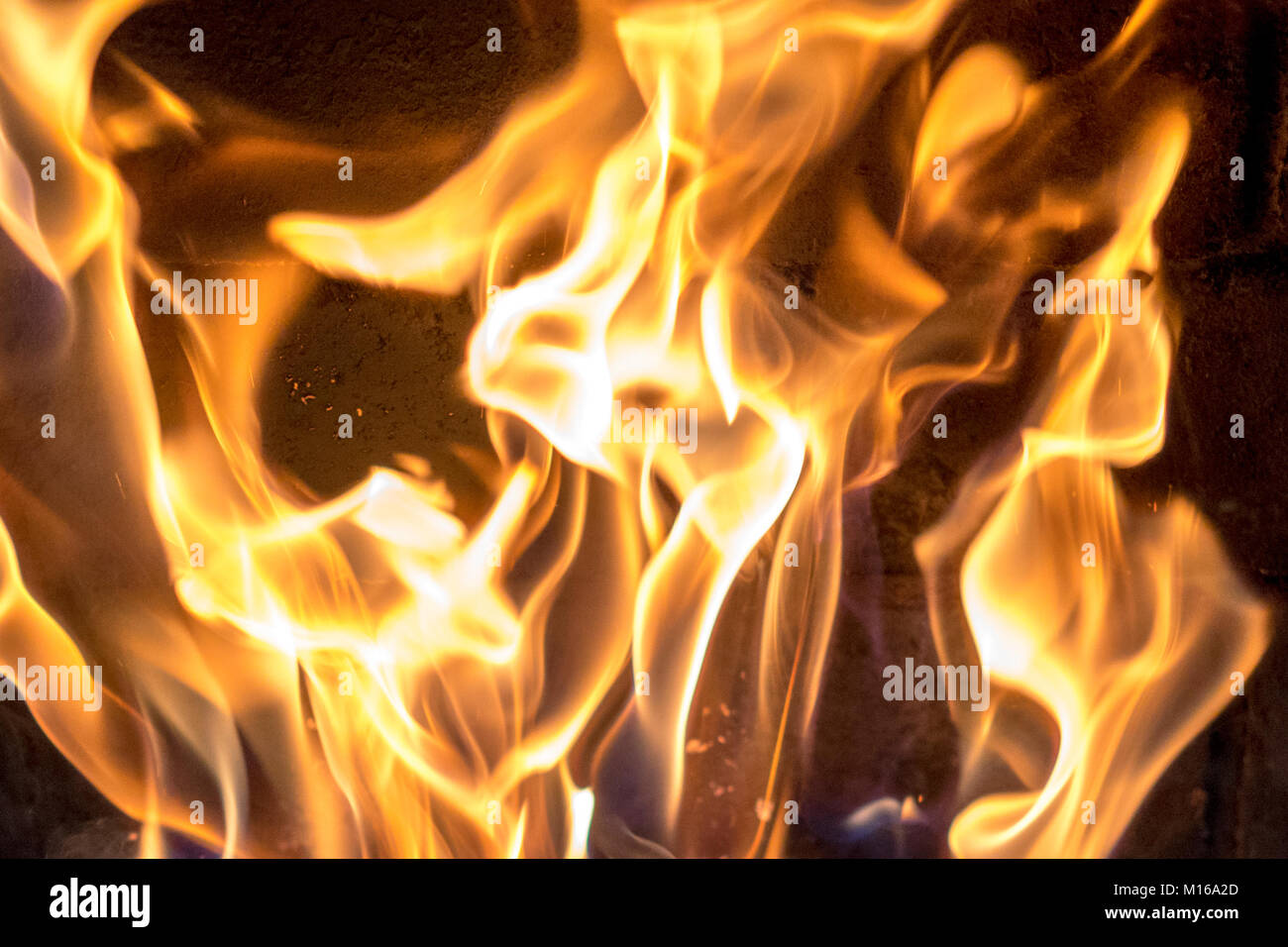 red yellow fire in the fireplace close-up. flames. Fire background ...