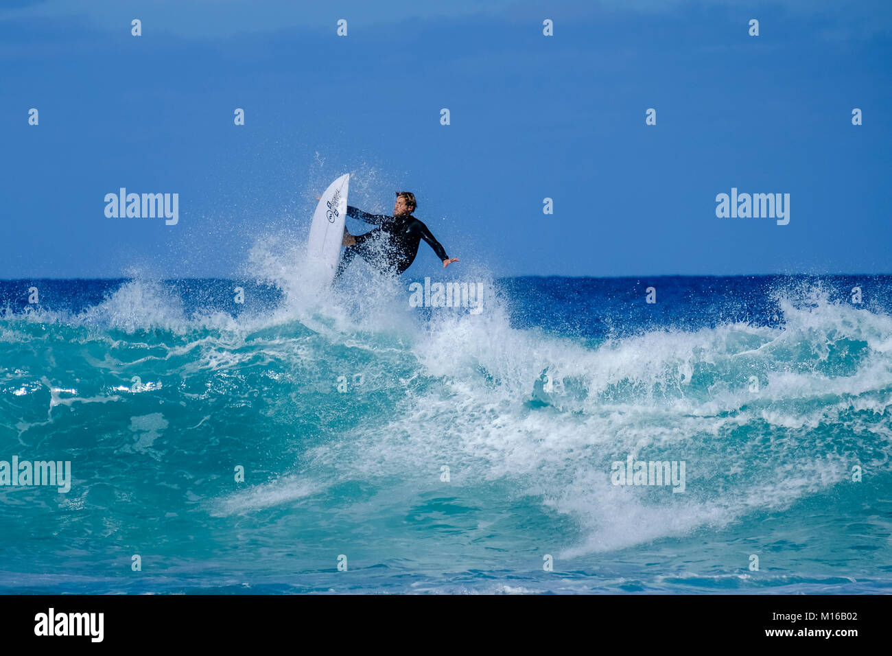Large wave surfers in the Atlantic Ocean, Playa Majanicho, Fuerteventura, Canary Islands, Spain Stock Photo