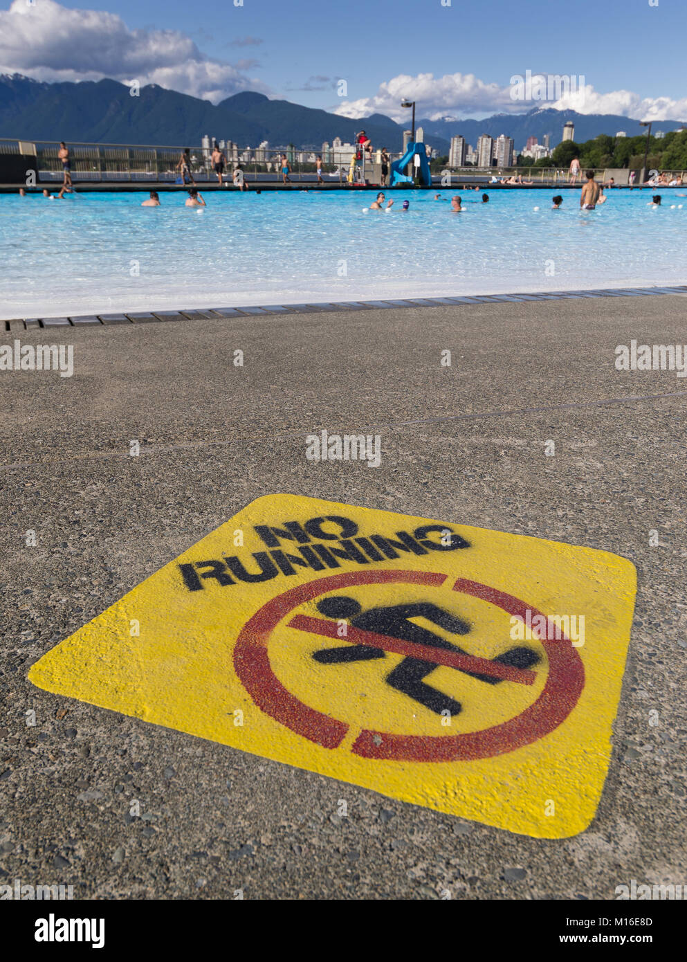No running sign next to Kitsilano outdoor swimming pool. Stock Photo