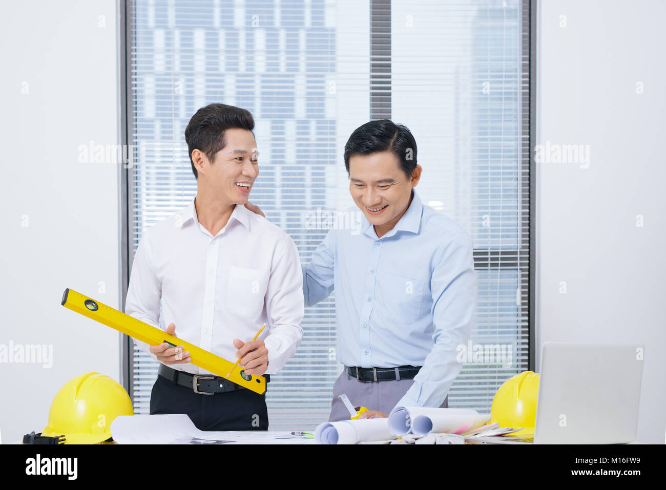 Male coworkers discussing ideas  about project in office, architectural concept Stock Photo