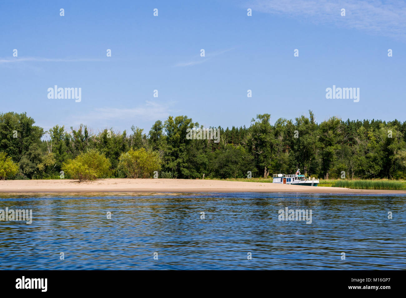 A small river ship is standing in the backwater on the river Volga. Stock Photo