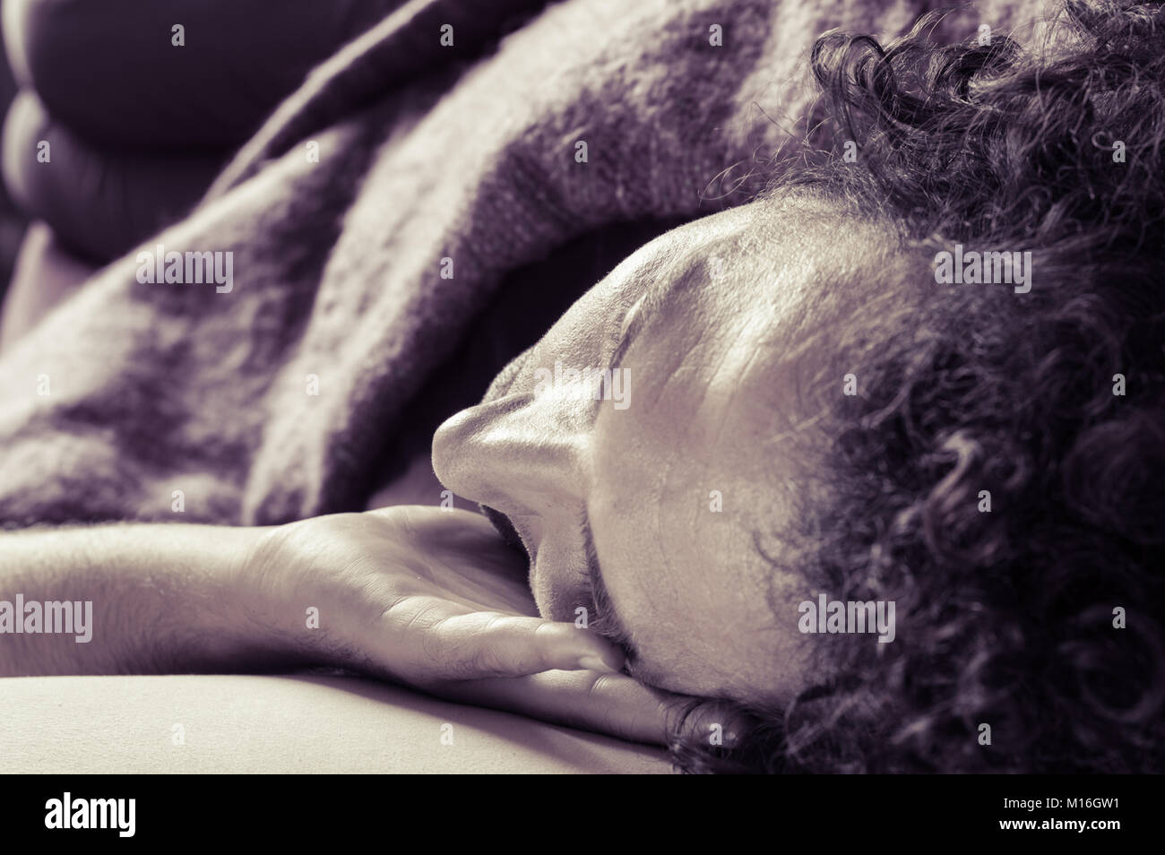 Young handsome man sleeping on the sofa Stock Photo