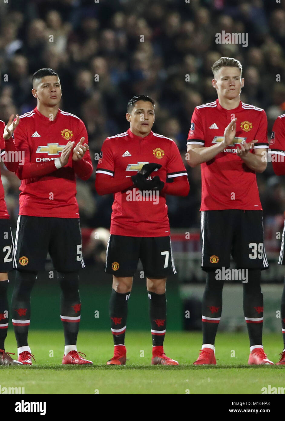 Manchester United’s Alexis Sanchez (centre) stands for a minute’s