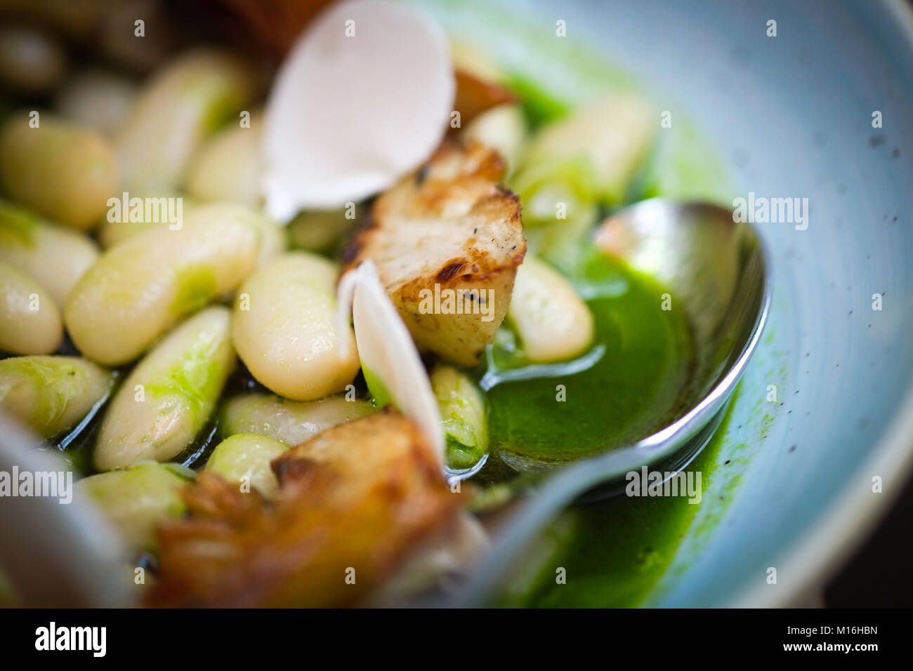 Faves bean stew with parsley, almonds and artichoke, modern Spanish tapas, comida Espanola. Stock Photo