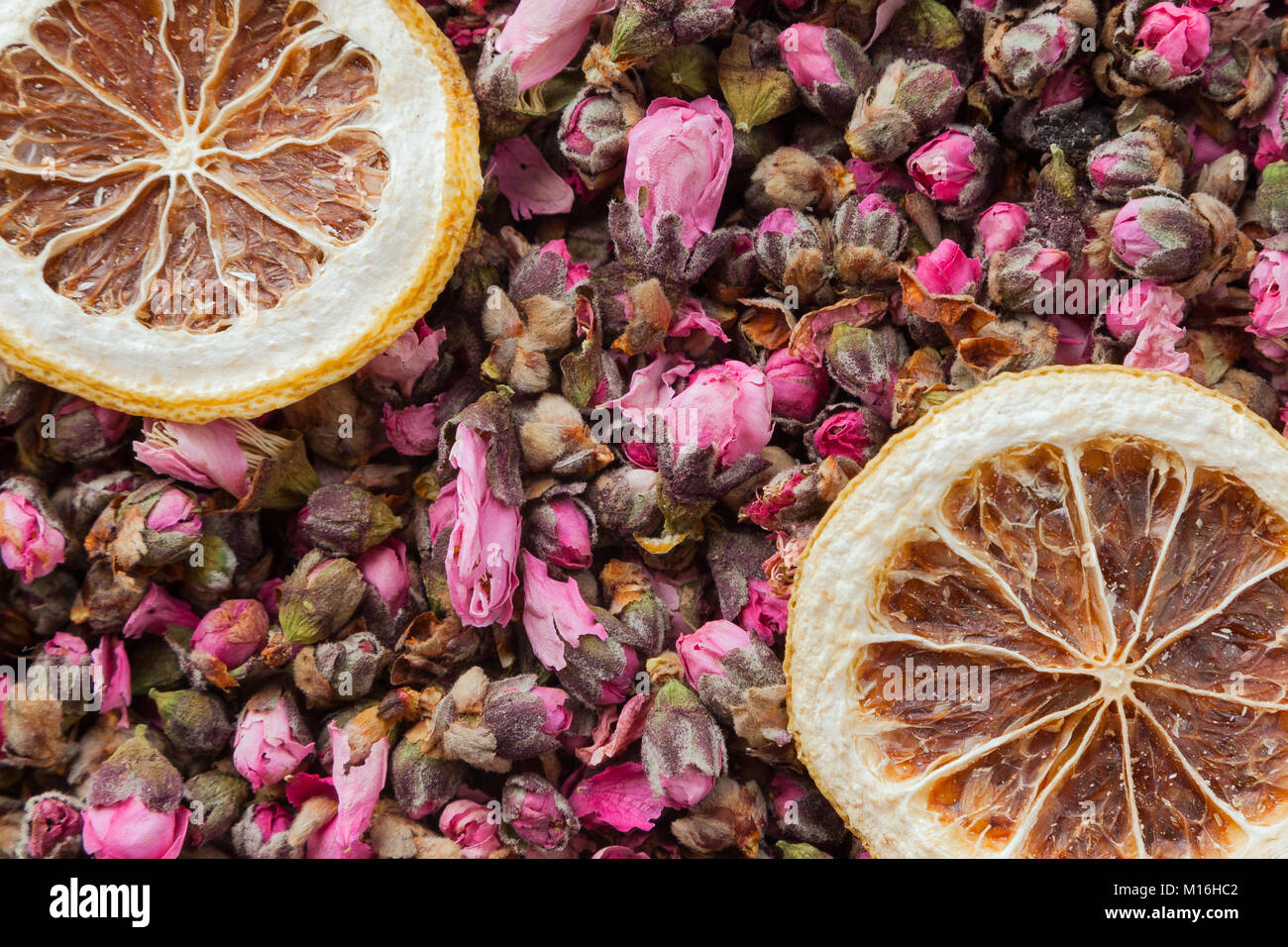 Tea flowers texture. Peach blossom tea with lemon. Organic dried flower tea leaves Stock Photo