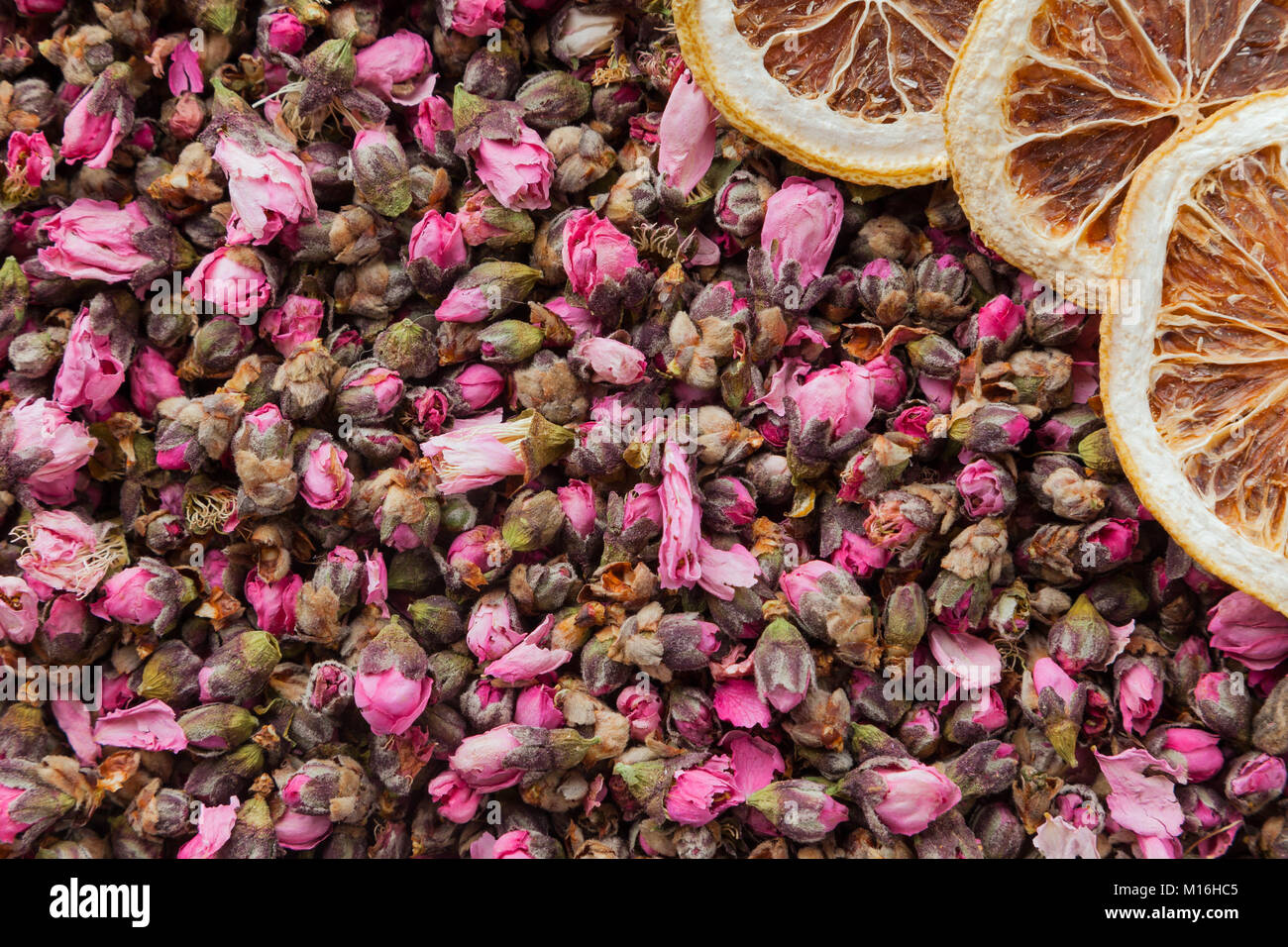 Tea flowers texture. Peach blossom tea with lemon. Organic dried flower tea leaves Stock Photo