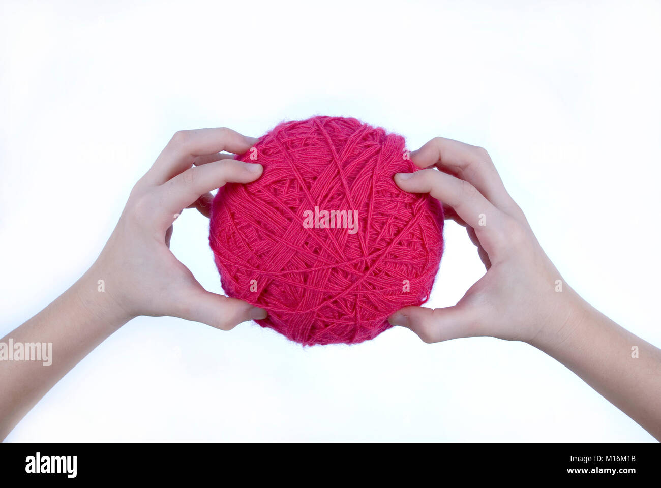 red threads clew in hands isolated on a white background Stock Photo ...
