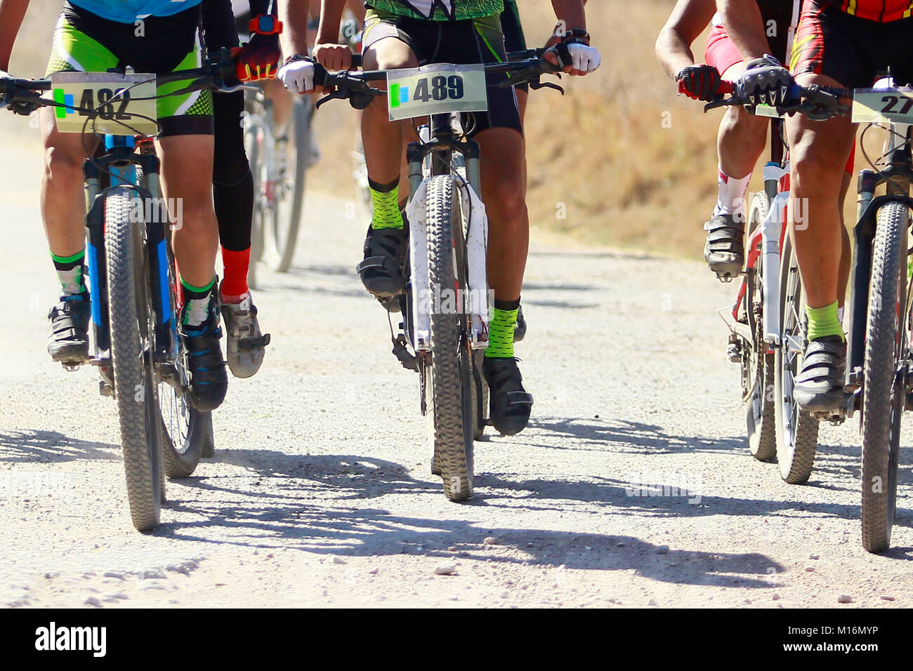 A group of male cyclist in a xc race in a dusty trail in Tlaxcala, Mexico Stock Photo