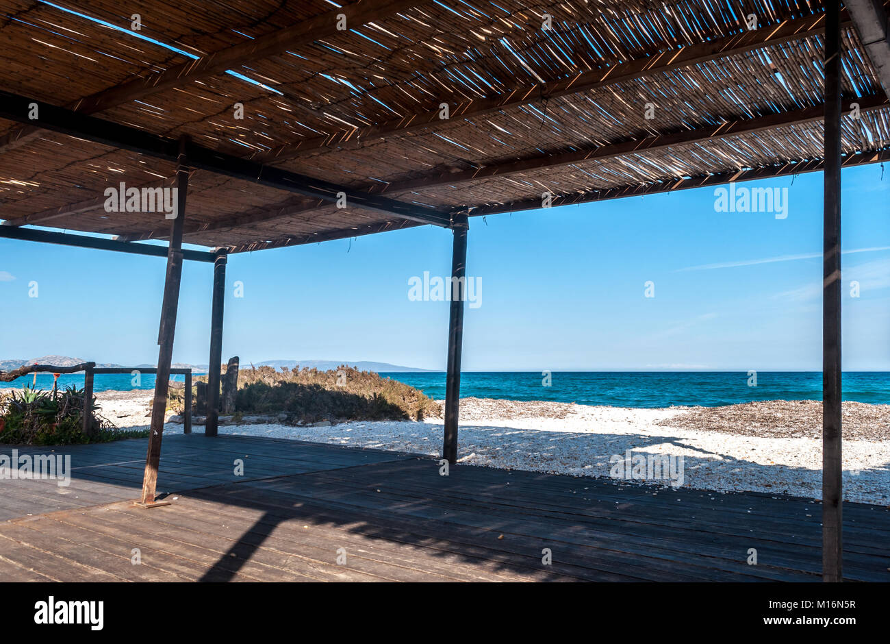 View of the sea from a reed gazebo on the beach in summer Stock Photo — free download