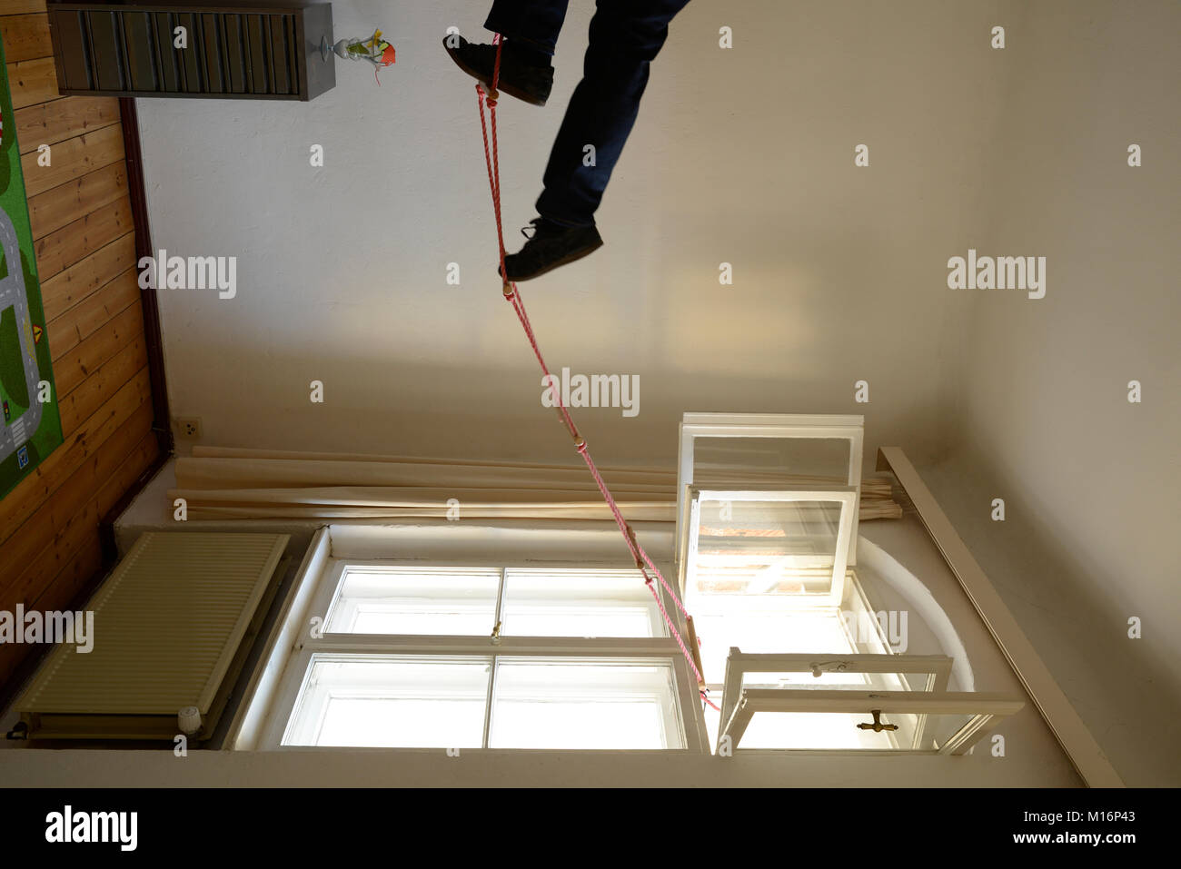 changed perspective a man is climbing down a rope Stock Photo Alamy