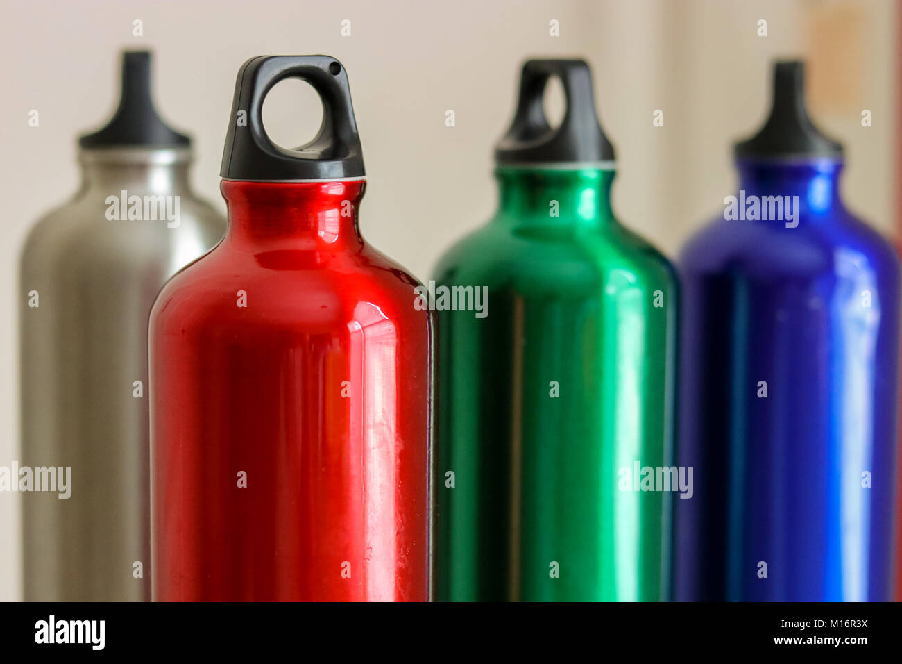 four Metal water bottles silver red green blue Stock Photo