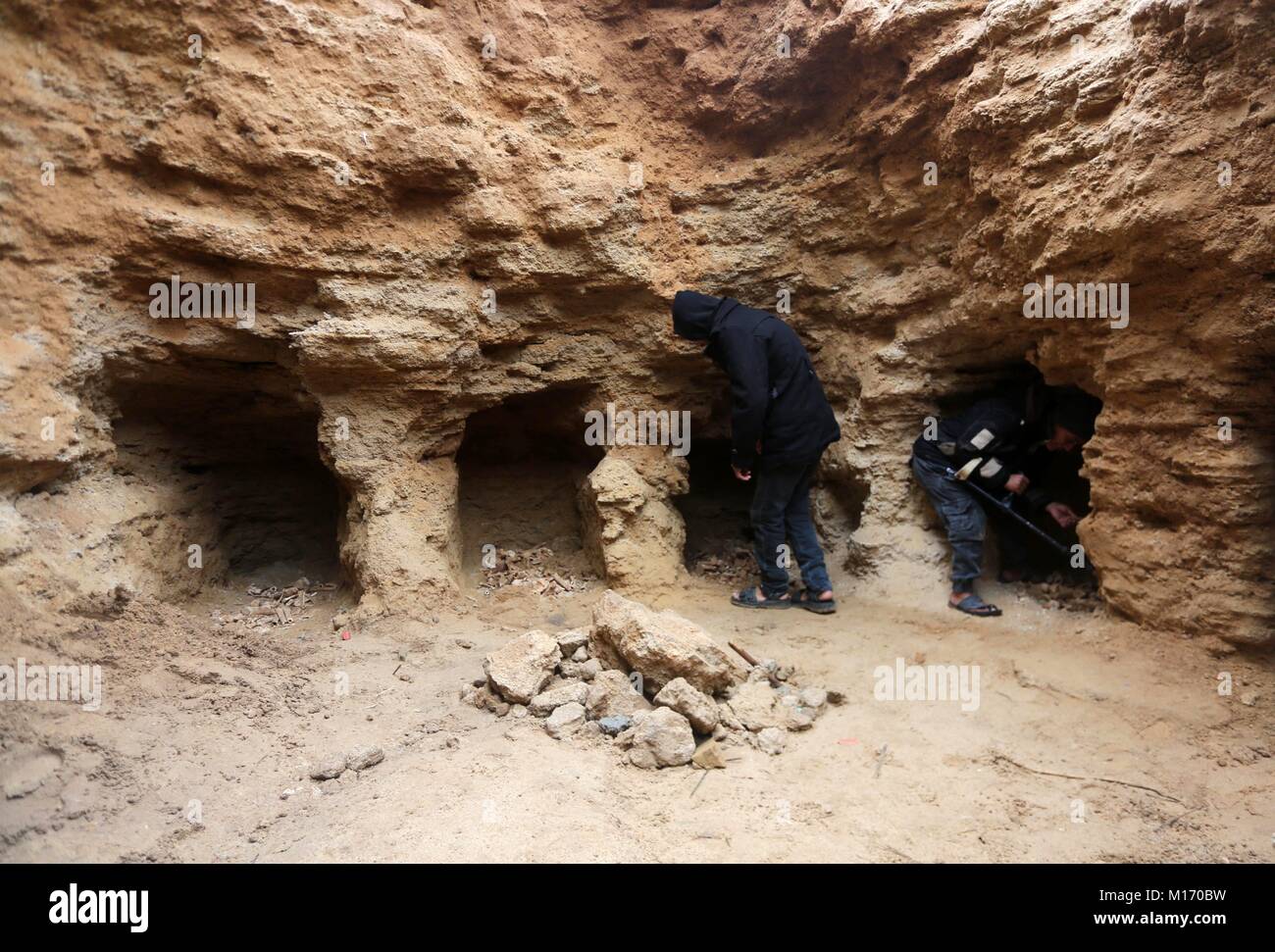 Beit Hanoun, Gaza Strip, Palestinian Territory. 28th Jan, 2018. Palestinians gather at a freshly-discovered cemetery which was found by Abdelkarim al-Kafarna in his backyard in town of Beit Hanoun, in the northern Gaza strip on January 27, 2018. Experts said the graves were part of a loculus tomb that possibly dates from the late Roman-Byzantine era in the fourth to sixth century CE where Gaza was part of the far-flung Roman Empire Credit: Mohammed Asad/APA Images/ZUMA Wire/Alamy Live News Stock Photo