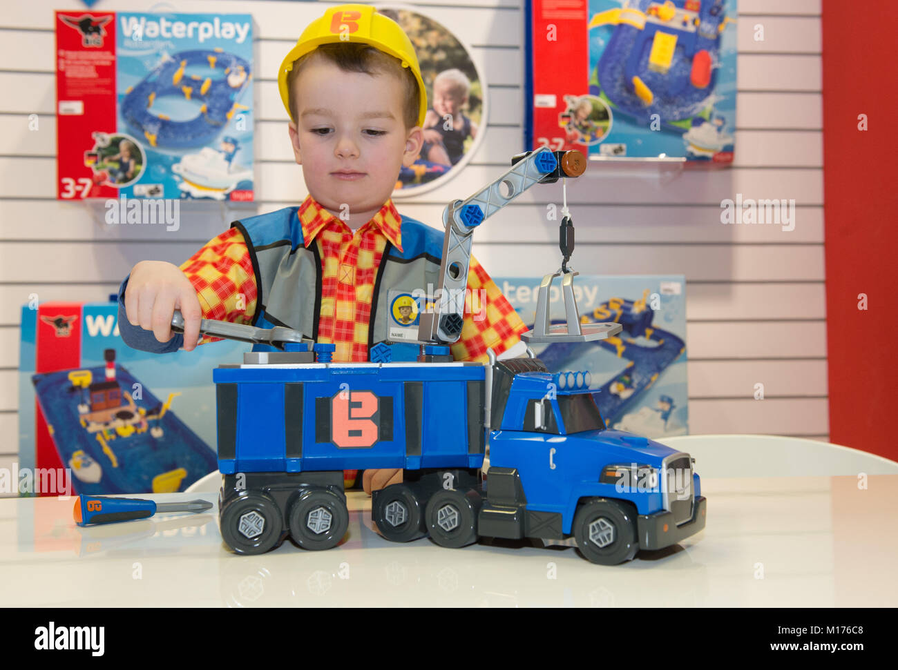 Alexander plays with a toy vehicle called 'Schleppo' by Smoby during the annual press meeting of the toy manufacturers Simba Dickie and Maerklin regarding the Nuremberg International Toy Fair, in Fuerth, Germany, 26 January 2018. Photo: Timm Schamberger/dpa Stock Photo
