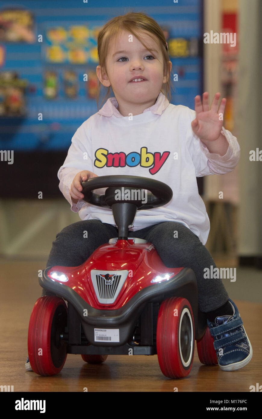 Fuerth, Germany. 26th Jan, 2018. Lena rides on a toy vehicle called 'Bobby-Car' by Simba Dickie during the annual press meeting of the toy manufacturers Simba Dickie and Maerklin regarding the Nuremberg International Toy Fair, in Fuerth, Germany, 26 January 2018. Credit: Timm Schamberger/dpa/Alamy Live News Stock Photo