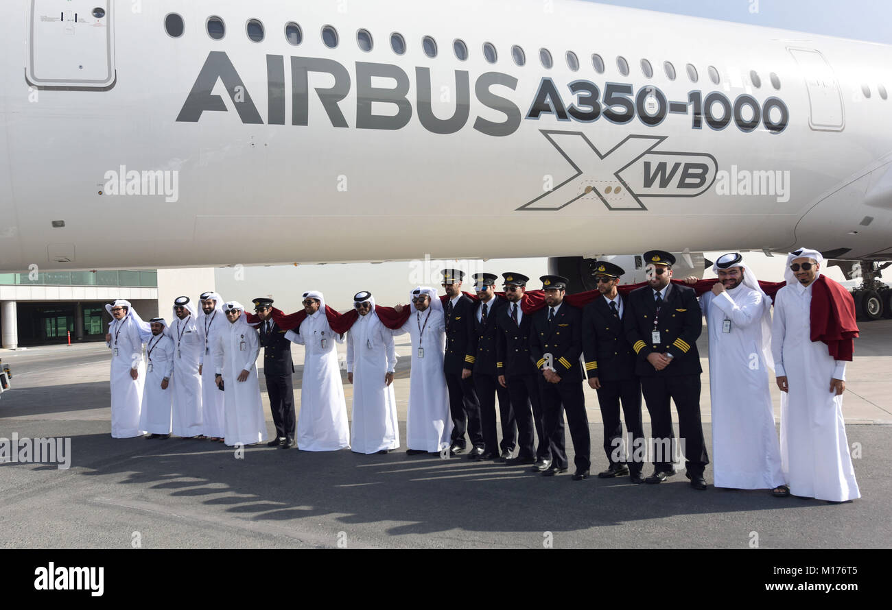 Doha, Qatar. 27th Jan, 2018. Qatar Airways staff pose for photos next to an Airbus A350-1000 jet at Doha International Airport in Doha, capital of Qatar, on Jan. 27, 2018. The brand new aircraft arrived in Doha as part of its demonstration tour to 12 Middle East and Asian-Pacific destinations. Credit: Nikku/Xinhua/Alamy Live News Stock Photo